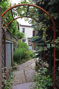 75A Garden Ave beautiful mature garden with a trellis and charming stone path