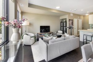 441 Jane St #410 living room with sectional couch and wall mounted tv