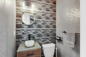 441 Jane St #410 powder room with black and white tile and vessel sink