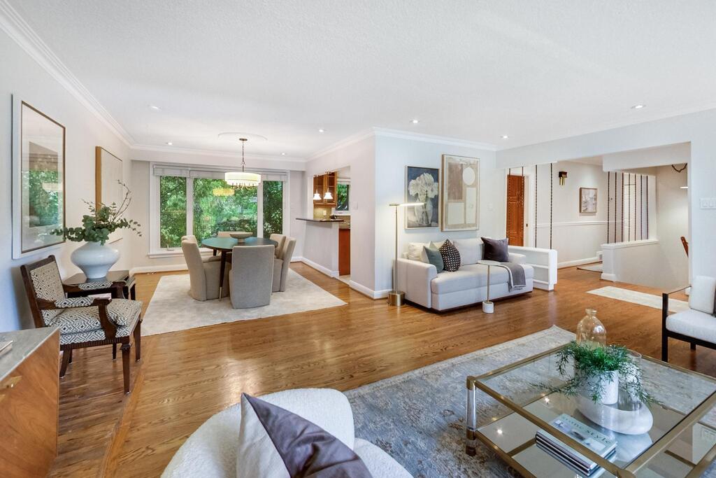 Spacious open-concept living and dining room with hardwood floors, large windows, and modern staging at 12 Vistaview Blvd