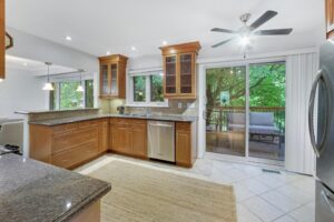 Kitchen with granite countertops, wood cabinetry, stainless steel appliances, and tile backsplash at 12 Vistaview Blvd.
