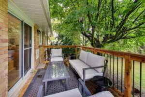 Private deck off the kitchen at 12 Vistaview Blvd overlooking a mature tree and backyard greenspace.