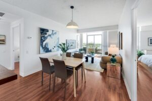 8 Covington Rd #1412 open-concept living and dining room facing the sliding door to the balcony